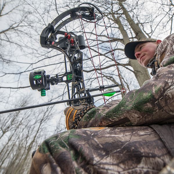 hunting-prostaff-lifestyle-10 guy sitting outside with his bow and arrow